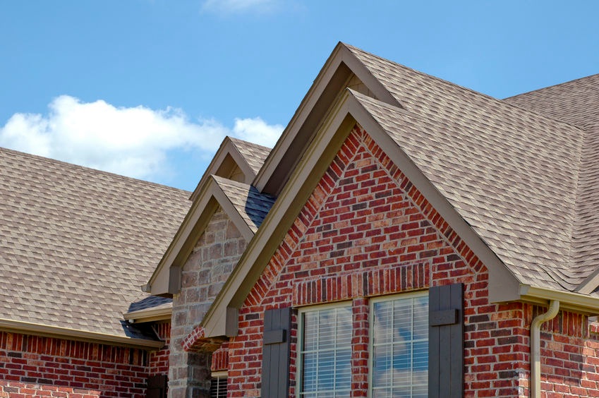 A newly installed asphalt shingle roof on a brick home, providing superior protection against Southeastern North Carolina’s coastal weather.