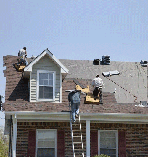 Coastal Roofing Experts' team replacing a residential roof in Southeastern NC, ensuring durability and protection against coastal weather.