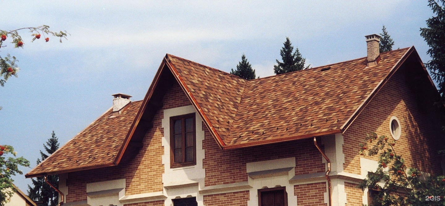 A newly installed brown shingle roof on a brick home, providing weather-resistant protection for coastal homes in Southeastern North Carolina.