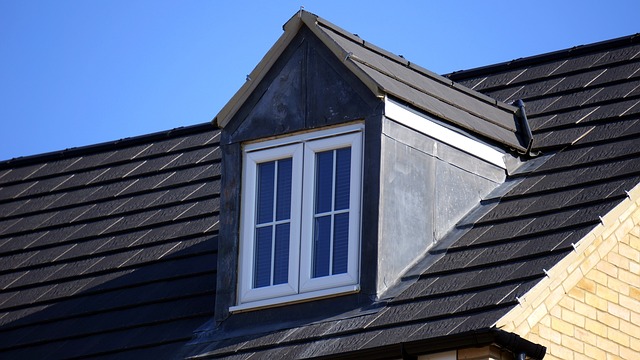 A modern black tile roof with a dormer window, expertly installed for residential roofing durability in coastal North Carolina.